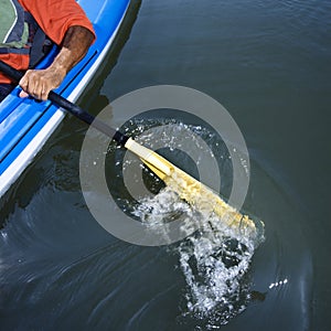 Man paddling kayak.