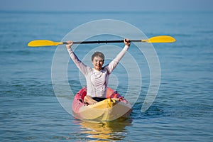Man paddling a kayak boat in sea