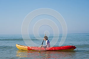 Man paddling a kayak boat in sea