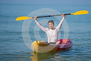 Man paddling a kayak boat in sea