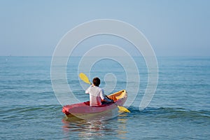 Man paddling a kayak boat in sea