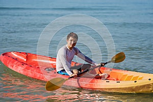 Man paddling a kayak boat in sea