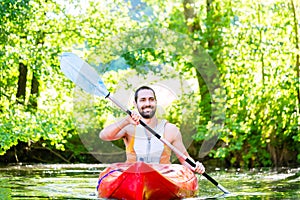Man paddling with kayak on river