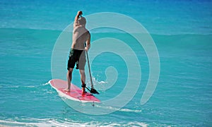 Man paddling out on paddle board