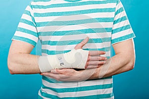 Man with painful bandaged hand.