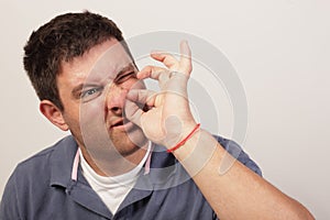 Man painfully picking his nose hair