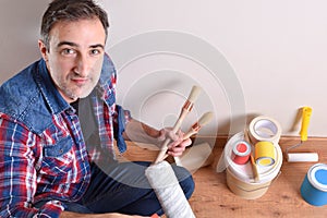 Man with paint tools on hands top elevated view