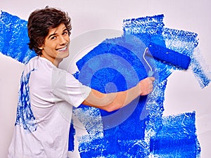 Man paint wall at home