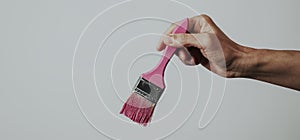 Man and paintbrush with pink paint, web banner