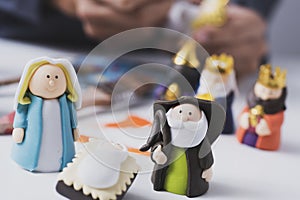 Man painting figurines of a nativity scene