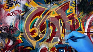 Man Painting Graffiti Art On Wall