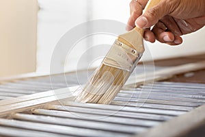 Man painting his home indoor. Brush and paint tools