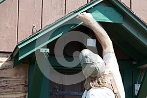 Man painting his house facade