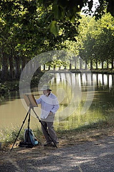 Man painting on riverside