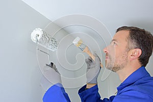 Man painting wall in diy concept