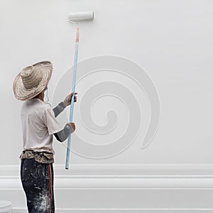 Man painting the wall in white color.