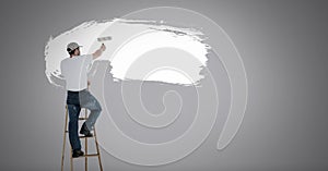 Man painting white on wall
