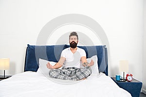 Man pajamas sit bed bedroom morning meditation, calm down concept