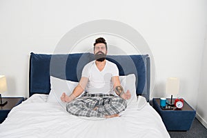 Man pajamas sit bed bedroom morning meditation, peace of mind concept