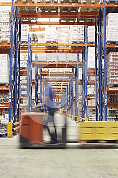 Man With Pallet Jack Through Warehouse