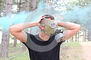 Man panicking in the forest with gas mask