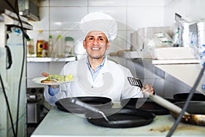 man with pans with kebab plate