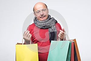 Man with paper bags after shopping feeling tired and exhausted