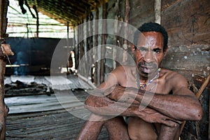 Man of Papuan Korowai tribe in the house on a tree