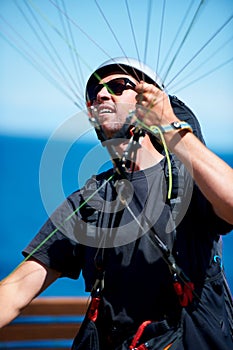 Man, parachute and paragliding launch in air in nature, exercise and healthy adventure fof extreme sport. Person, glide