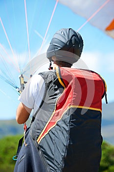 Man, parachute or paragliding launch in nature, exercise or healthy adventure for extreme sport. Person, strings or