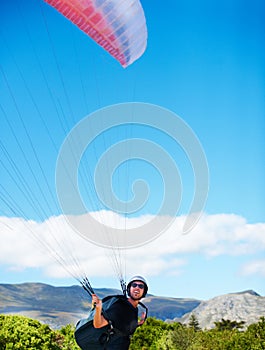 Man, parachute or paragliding sport in preparation exercise, healthy adventure or extreme fitness. Person, launch or