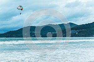 A man parachutes for a jet ski, entertainment at sea