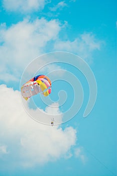 Man parachuting above the sea