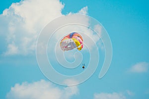 Man parachuting above the sea