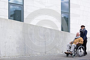 Man with paralysis and carer