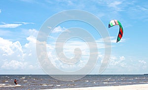 Parasailing in the Gulf of Mexico with beautiful blue sky and white sand