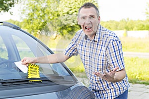 Man with parking ticket