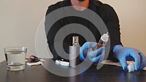 A man parses an electronic cigarette and checks its performance