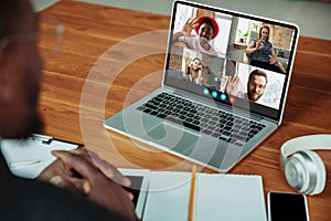 Man participate video conference looking at laptop screen during virtual meeting, videocall webcam app for business photo