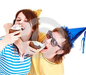 Man in party hat and girl eating cake.