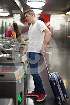 Man passing baffle gate in metro station