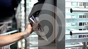 Man passing electronic turnstile, access control for business center, close-up