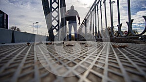 man passing metallic bridge in arganda del rey madrid spain photo