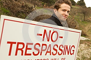 A Man Passing No Trespassing Sign photo