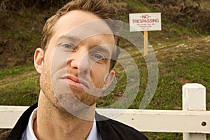 A Man Passing No Trespassing Sign photo