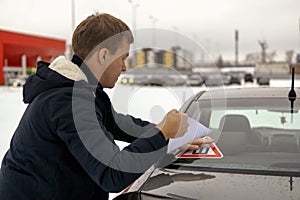 Man pastes thorn sign sticker on car window