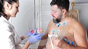 Man patient with ECG cardiogram of heart, holter