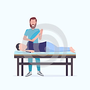 Man patient lying on massage table masseur therapist doing healing treatment massaging injured hand manual sport