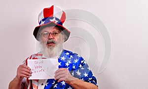 Man in patriotic costume holding up a Your vote counts sign