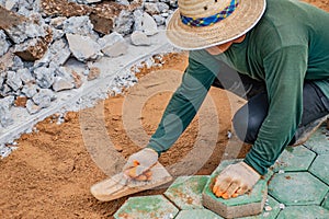 Workers is paving brick floors.